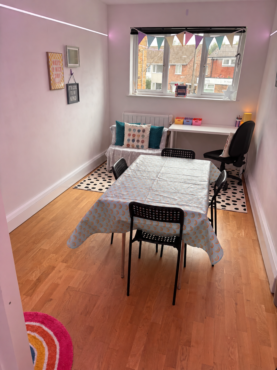 Our welcoming tuition room with a shared learning table, colourful bunting and a cosy seating corner